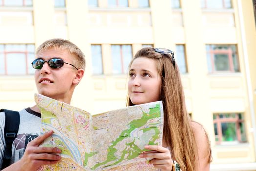 Couple tourists with map in city