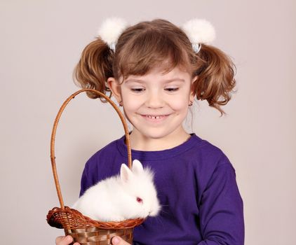 happy little girl hold white bunny