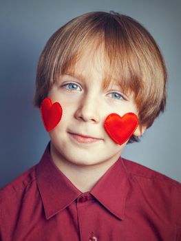 Portrait of a boy with hearts on face