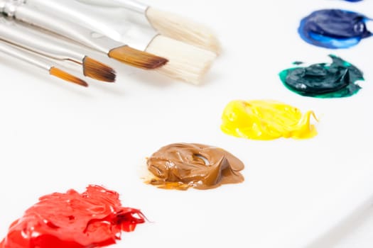 Set of artistic brushes and paints on white background