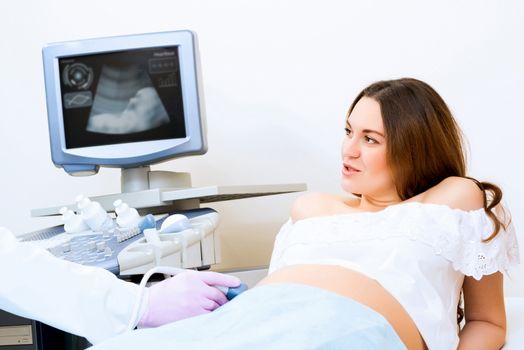 Young attractive pregnant woman on reception at the doctor, health check