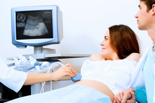 pregnant woman and the future father of the doctor's office, ultrasound diagnostics