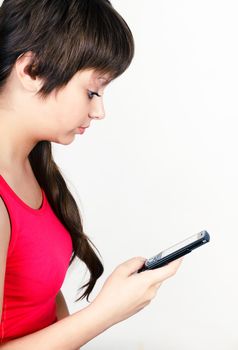 Young attractive girl writing or reading sms