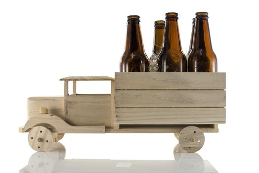 wooden car with beer bottles isoalted on white