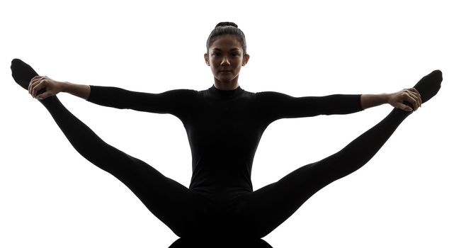 one caucasian woman practicing gymnastic yoga stretching split in silhouette  on white background