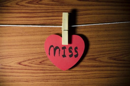 red heart word miss on wood vintage stlye background