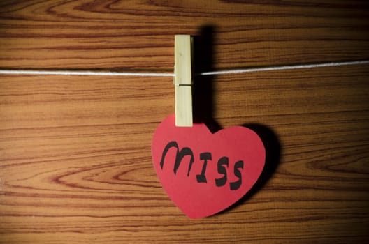 red heart word miss on wood vintage stlye background