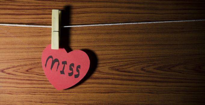 red heart word miss on wood vintage stlye background