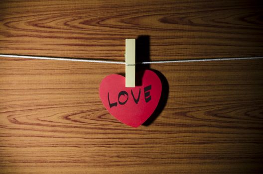 red heart word LOVE on wood vintage stlye background