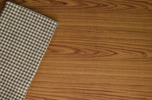 brown kitchen towel pattern on wood background