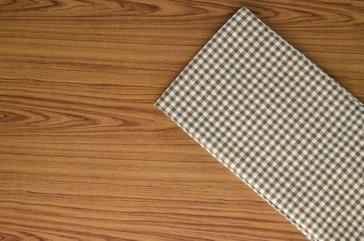 brown kitchen towel pattern on wood background