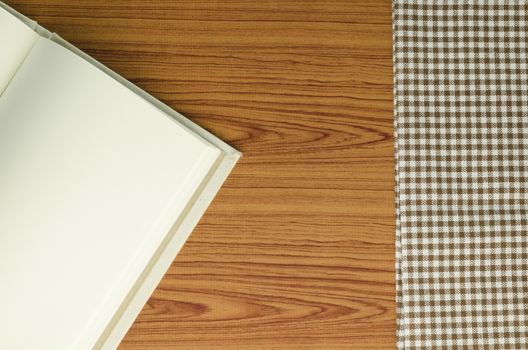 notebook with kitchen towel on wood background