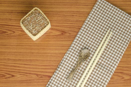 brown kitchen towel with spoon on wood background