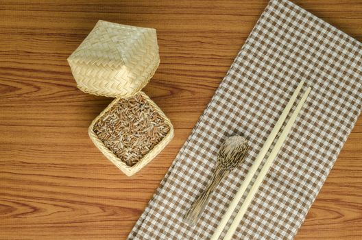 brown kitchen towel with spoon on wood background