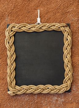 Rope frame on a blackboard used lika a copyspace