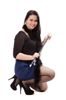 Young woman in retro clothes posing with a stick, on a white background