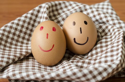 smile love egg couple in brown kitchen towel on wood table