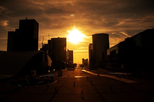 Sunset over skyscrapers in urban area of Paris