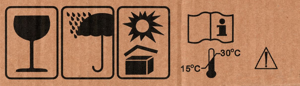 Image close-up of grunge black fragile symbol on cardboard