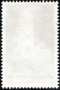 Blank vertical postage stamp isolated on a black background