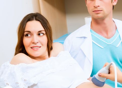 pregnant woman and the future father of the doctor's office, ultrasound diagnostics