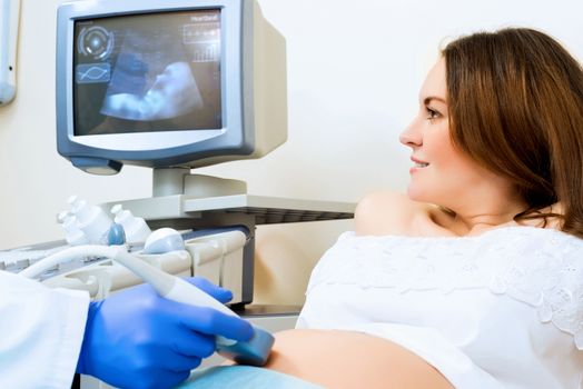 young pregnant woman on the ultrasound, health check