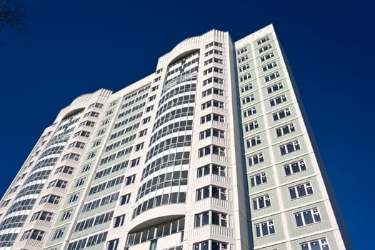 Beautiful view of modern apartment building under blue sky