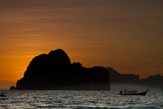 Sunset silhouettes at the beach of the Koh Ngai island Thailand