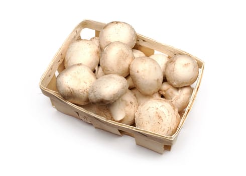 A lot of champignons in a wicker basket on white background