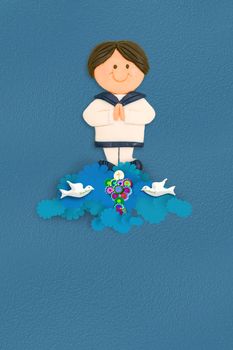 cheerful boy first communion dress sailor costume on blue background with empty space for text