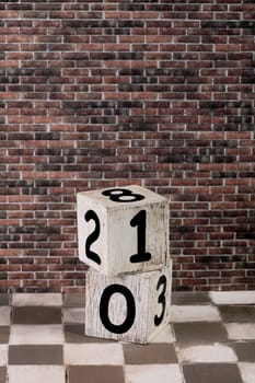 two dice and number on a brick wall