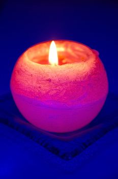 Orange candle on blue background