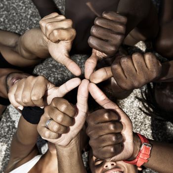 A group of mixed race people with hands doing thumbs up