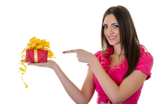 Happy Beautiful Brunette Young Woman pointing at Gift Box, Horizontal shot over white background 
