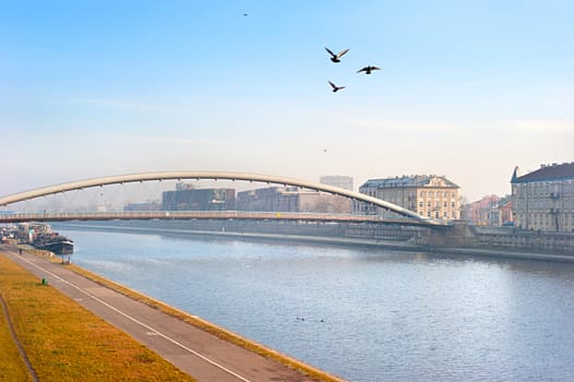 Krakow skyline with Father Bernatek Footbridge (K��adka Ojca Bernatka)  across the Wisla river