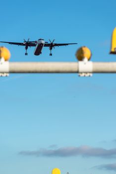 Airport landing lights with airplane approaching runway lighting.