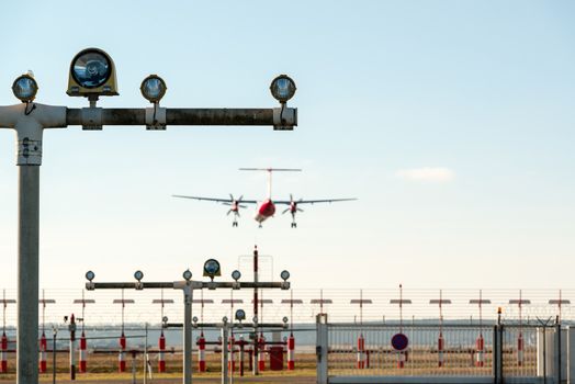 Airport landing lights with airplane approaching runway lighting.