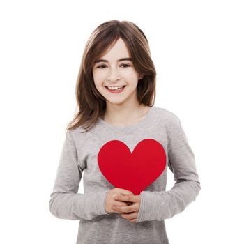 Little girl holding a heart made with paper , isolated over a white background