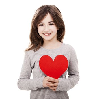 Little girl holding a heart made with paper , isolated over a white background