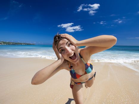 Beautiful and happy young woman  enjoying the summer on a tropical beach 