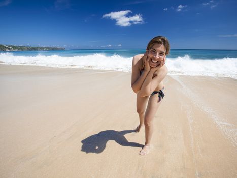 Beautiful and happy young woman  enjoying the summer on a tropical beach 