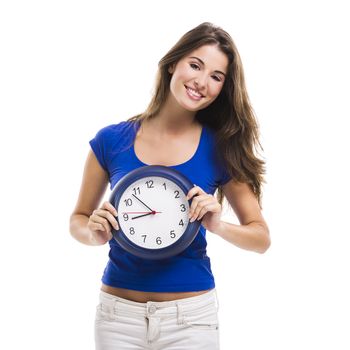Causal young woman holding a clock, isolated over a white background