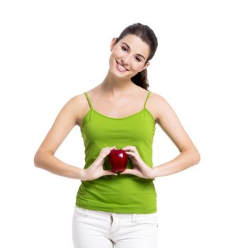 Healthy woman holding a fresh apple in front of the belly, isolated over a white