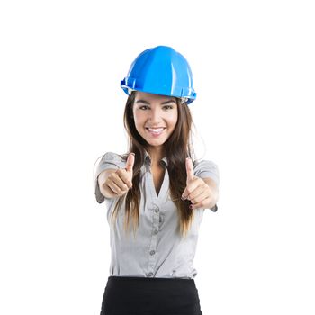 Beautiful and confident young female architect wearing a blue helmet with thumbs up, isolated on white