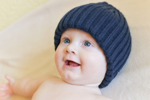 Portrait of a seven month old baby boy looking curious at the camera