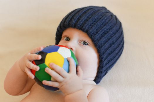 Portrait of a seven month old baby boy looking curious at the camera