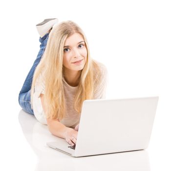 Beautiful woman lying on the floor and working with a laptop, isolated over white background