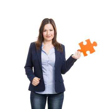 Business woman holding a puzzle piece, isolated over white