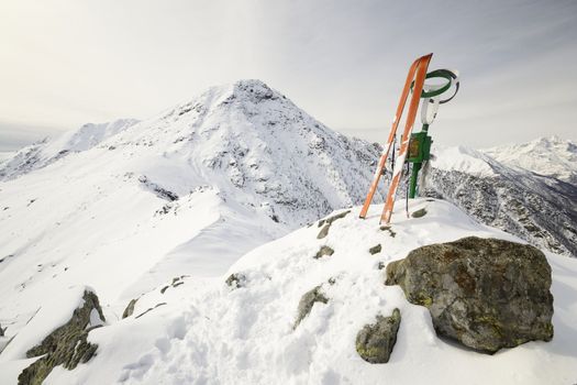 Pair of back country ski on the summit with amazing view on the alpine arc