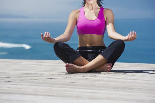 Beautiful young woman in outdoor doing yoga